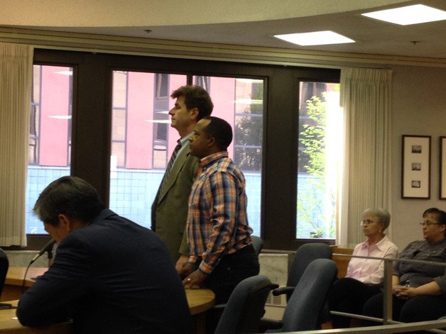 Federal Way school board member Tony Moore stands with his attorney as the judge reads him a guilty verdict on seven counts of first-degree theft at Multnomah County Courthouse in Portland