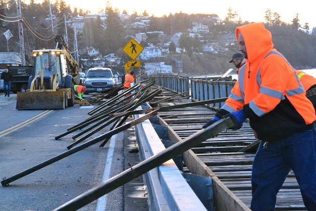 City of Des Moines Public Works employees pull loose planks from the boardwalk at Redondo Beach