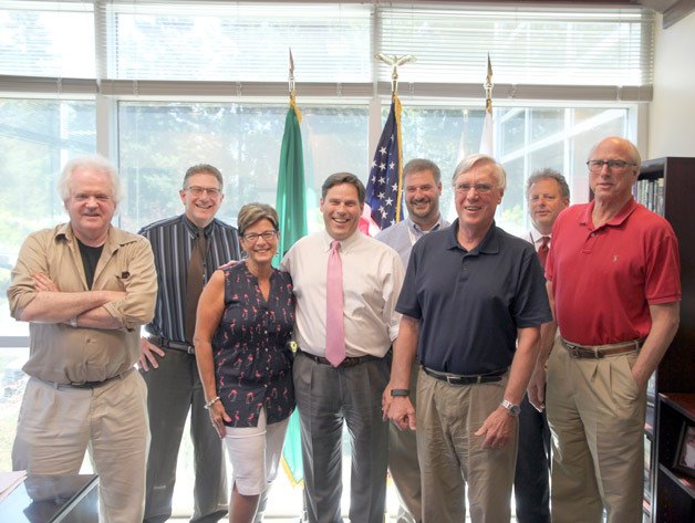 Mayor Jim Ferrell (fourth from left) stands with city officials and Centerstage Theatre board members. Following nearly three months of negotiations