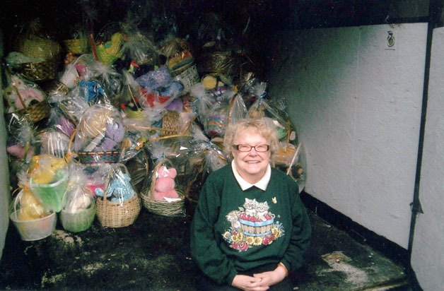 Hope Elder sits in front of the hundreds of Easter baskets she helped prepare for children this spring. The baskets will be donated to the Multi-Service Center.