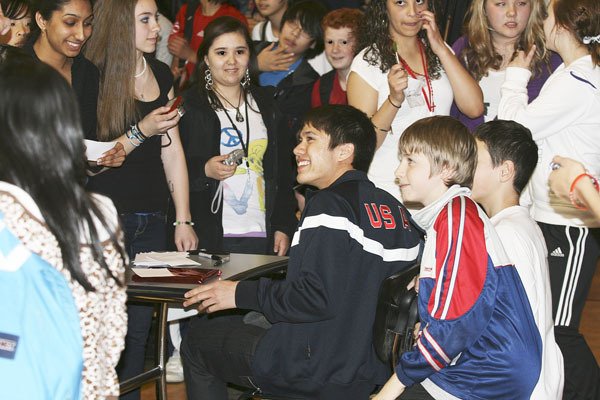 Dozens of Illahee Middle School students surround JR Celski during an assembly at the school on May 4. Celski attended Illahee