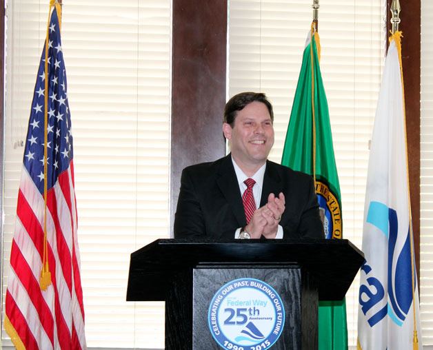 Mayor Jim Ferrell applauds while he delivers the state of the city address during a luncheon on Wednesday.