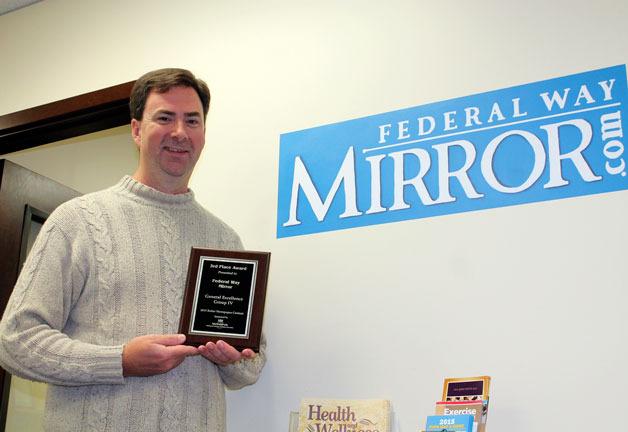 Mirror publisher Rudi Alcott holds up the prestigious third place General Excellence award the newspaper received from the Washington Newspaper Publishers Association during the organization’s annual Better Newspaper Contest event on Oct. 9 in Everett.