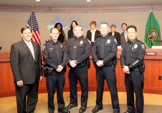 Mayor Jim Ferrell (left) and Chief Andy Hwang (right) with new officers Michael Henrich