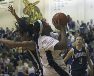 Federal Way High School sophomore TyShana Burgess goes up for a shot during Tuesday's 66-63 win over the Auburn Riverside Ravens in an SPSL tiebreaker game at Auburn High School. Burgess finished with 19 points and nine rebounds for the eighth-ranked Eagles.