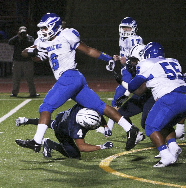 Federal Way senior fullback Rod Jones jumps over a Beamer tackler during the Eagles' 52-14 win over the Titans Friday at Federal Way Memorial Stadium. The win kept Federal Way unbeaten at 6-0.