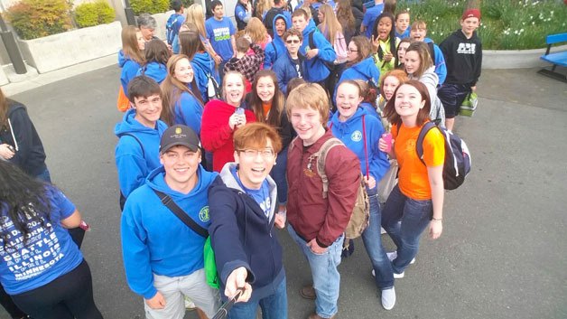 Todd Beamer High School students pose for a photo by the Key Arena during the We Day event in Seattle on Thursday.