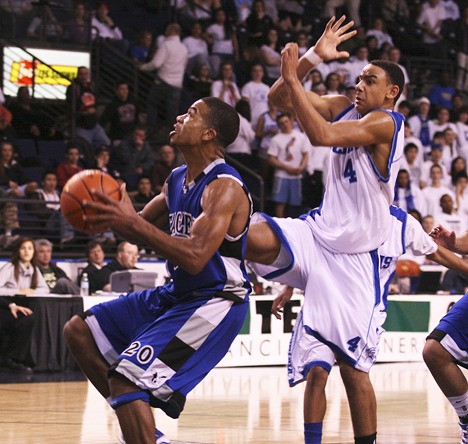 Federal Way High School senior Robert Christopher goes up for a shot in front of Curtis defender Devonte Lacy during the Eagles' 59-52 win over Curtis in the SPSL championship game Thursday at Kent's ShoWare Center.