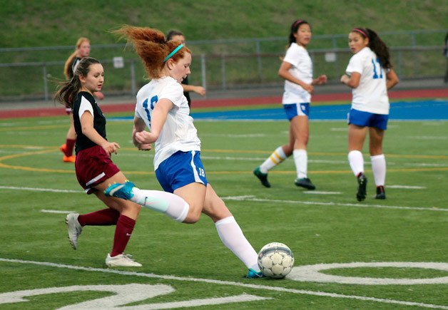 Brynn Ward attempts a shot for Federal Way as Kentlake's Sam Martin looks on. The Falcons defeated the Eagles 1-0 on Friday at Federal Way Memorial Stadium.