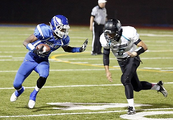 Federal Way senior D’Londo Tucker stiff arms a Spanaway Lake defender during the Eagles’ 42-13 win over the Sentinels Friday night. The unbeaten Eagles play Auburn (6-1) at 7 p.m. Friday night at Auburn's Troy Field.