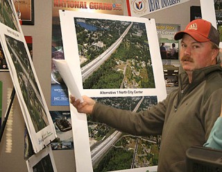 Kevin Dahl looks at depictions of proposed changes to South 312th Street. Dahl lives on the east side of Interstate 5. His home is one of approximately 17 that could be affected by an extension of South 312th Street from its current location to Military Road South.