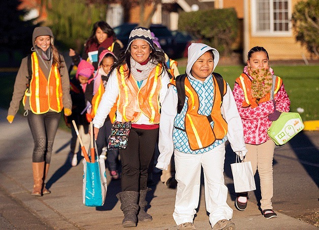 Students from Mark Twain Elementary School walked from home to school instead of taking the bus last Wednesday morning