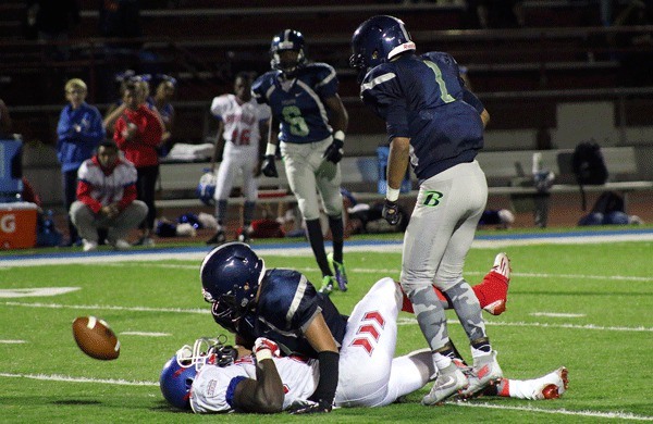 Beamer players break up a late fourth quarter pass attempt in their 20-6 win over Kent-Meridian on Friday