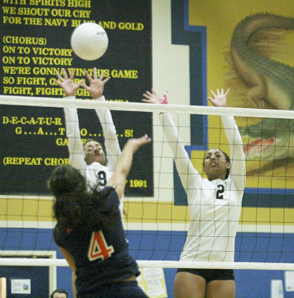 Decatur volleyball players Kendall Jensen (left) and Alishia Wilson attempt to block a spike by Lakes' Keilani Afalava during Wednesday night's SPSL 3A matchup at Decatur. No scores were reported.