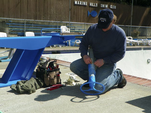 Dean Hutchinson assembles the refurbished diving board at Marine Hills Pool in Federal Way.