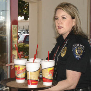 School resource officer Stacy Eckert delivers drinks to Special Olympics and Tip-A-Cop participants April 12 at Red Robin.