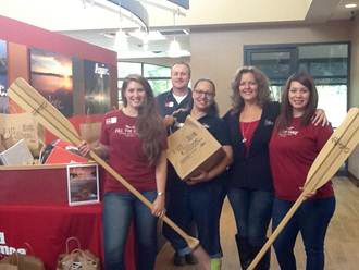 Red Canoe staff in 2015 with donated supplies received for Federal Way students. File photo