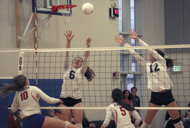 Mckenna Milholland (left) and Savanna Service (right) attempt to block Graham-Kapowsin’s Julia Heronema. TERRENCE HILL