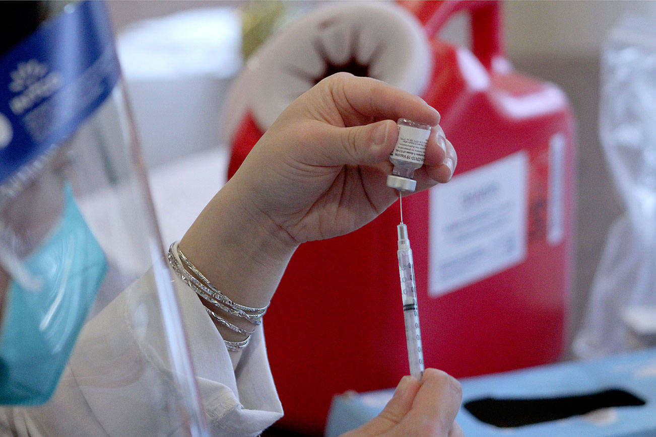 A CVS pharmacist prepares a COVID-19 vaccine at Village Green Retirement Campus in Federal Way on Jan. 26. Olivia Sullivan/the Mirror