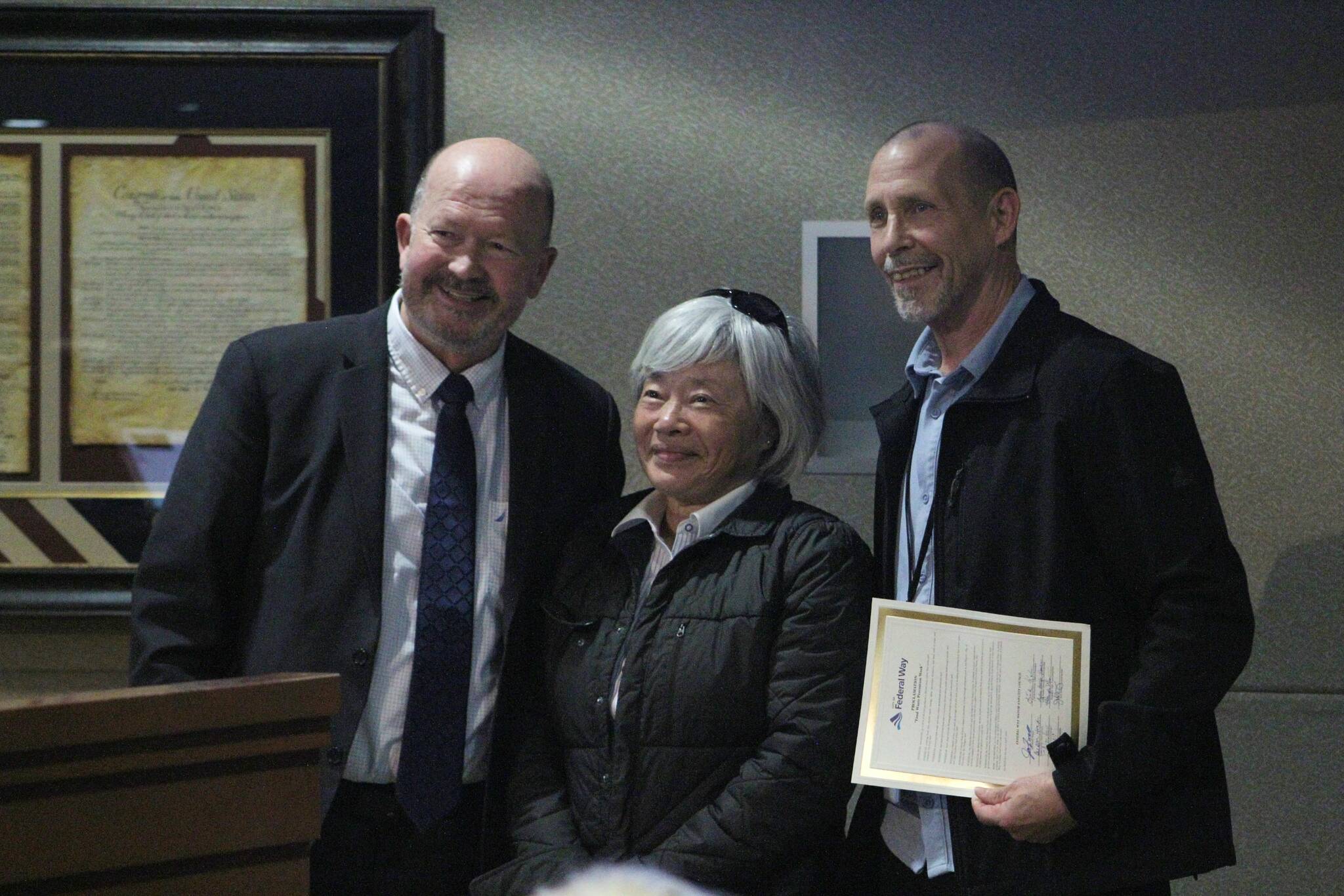 From left: Federal Way City Council member Jack Walsh, Federal Way Senior Center Food Bank director Kae Lee and Multi-Service Center Food Bank Director Steven Curry stand for a picture in celebration of Food Waste Prevention Week. Alex Bruell / The Mirror