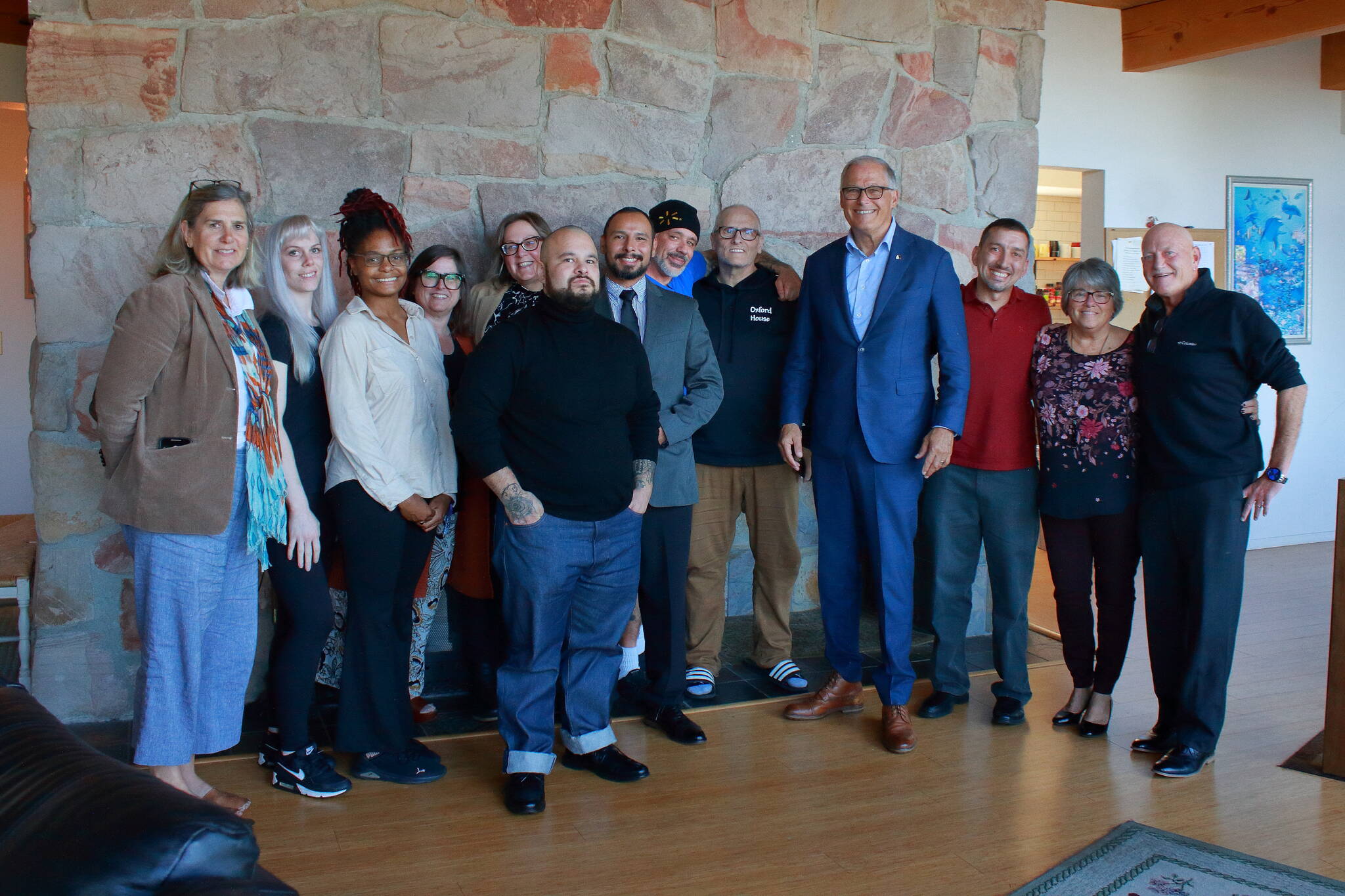 Gov. Jay Inslee poses with local Oxford House chapter representatives, residents and outreach workers along with staff from the Washington Healthcare Authority in Federal Way. Photos by Keelin Everly-Lang / The Mirror
