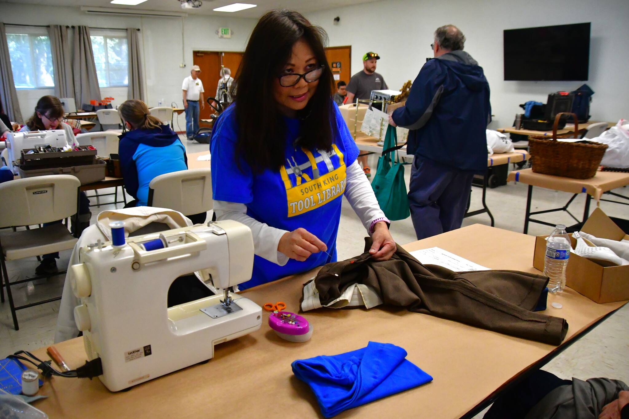 Sewing machines were available at Saturday’s event to help mend clothing in need of repair. Photo by Bruce Honda