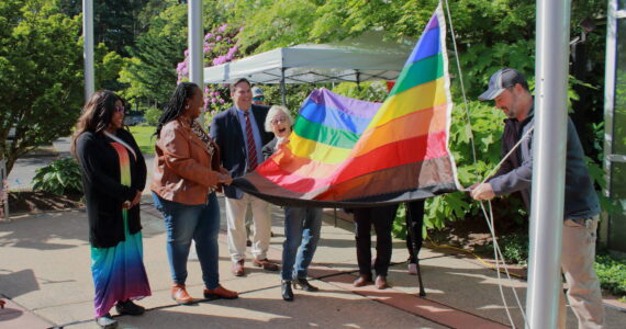 Community leaders raise the Pride flag. Photo by Keelin Everly-Lang / The Mirror