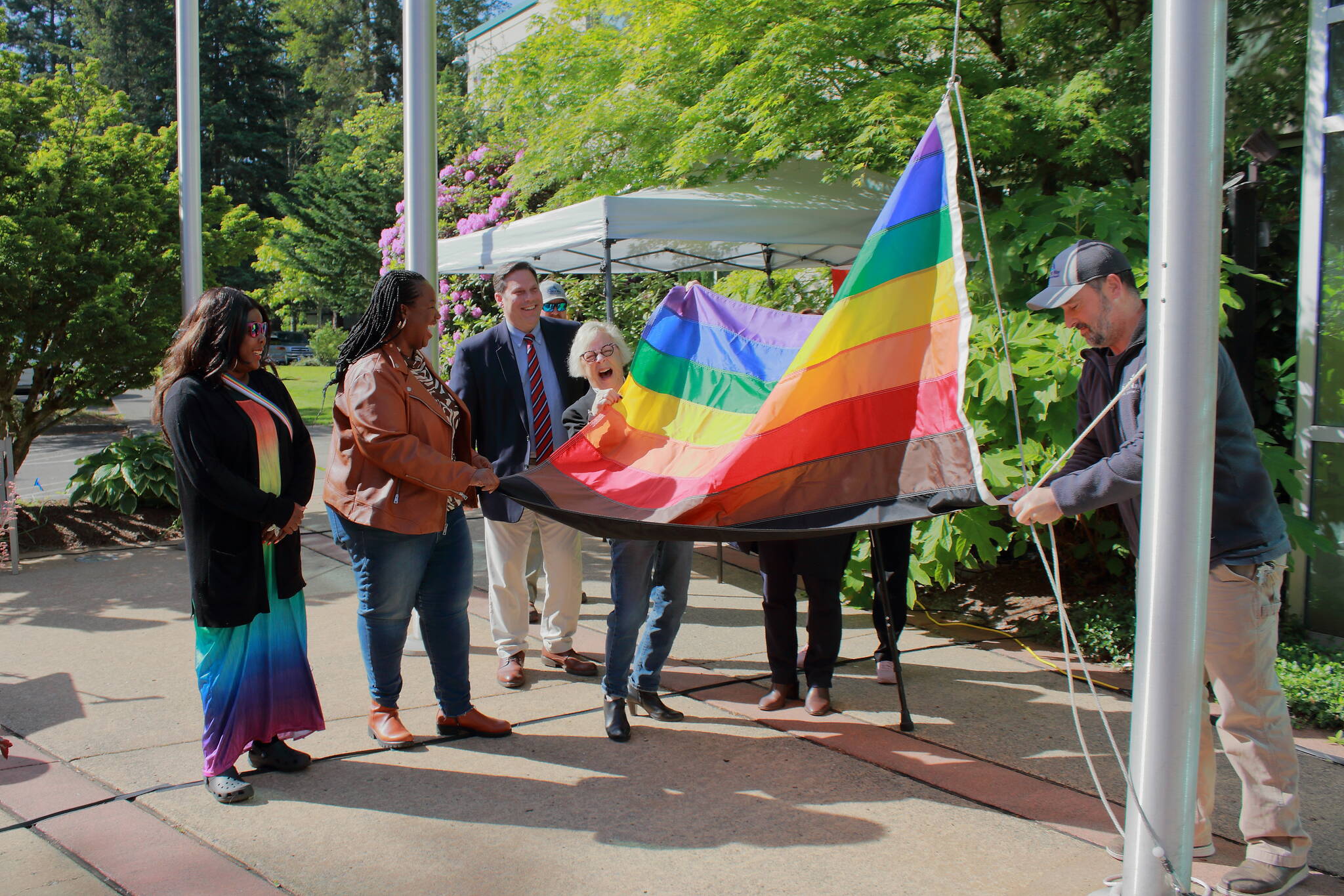 Community leaders raise the Pride flag. Photo by Keelin Everly-Lang / The Mirror