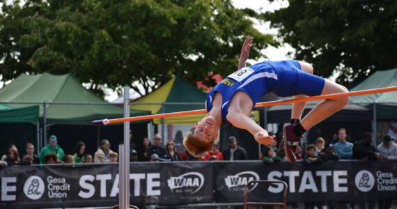 Hazen’s Illia Biezak leaps over the bar. Ben Ray / The Reporter