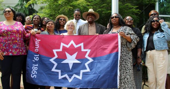 In 2023, city leaders and community members hold the Juneteenth flag outside Federal Way City Hall. File photo