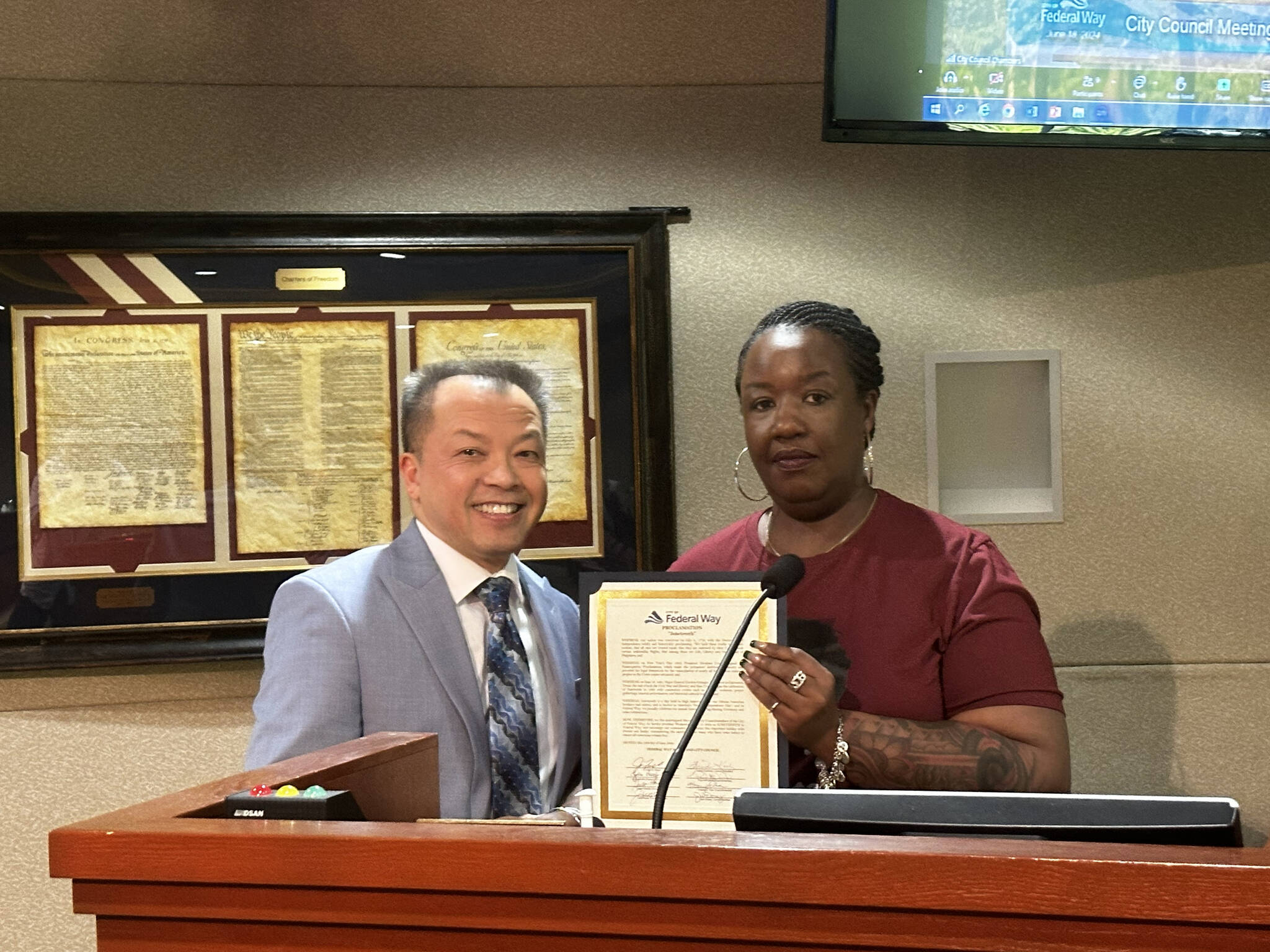 Federal Way City Councilmember Hoang V. Tran and Saudia Abdullah of the Diversity Commission hold the Juneteenth Proclamation. Photo by Joshua Solorzano/The Mirror