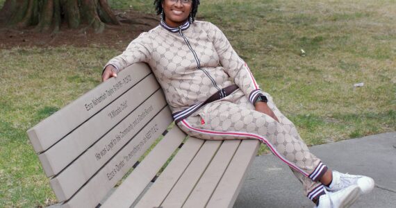 Selena Taylor on the bench that honors her son Ezra Taylor, who was killed by gun violence in 2021. Photo by Keelin Everly-Lang / The Mirror.