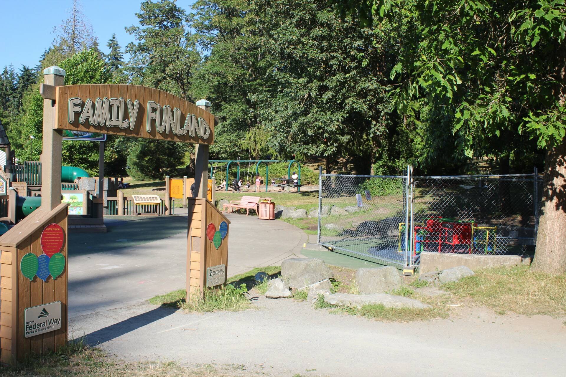 Next to the entrance to the Steel Lake Park playground in Federal Way, the inclusive AbilityWhirl can be seen behind fencing, closed off to the public as of July 10, 2024. Photo by Max Burchi / The Mirror.