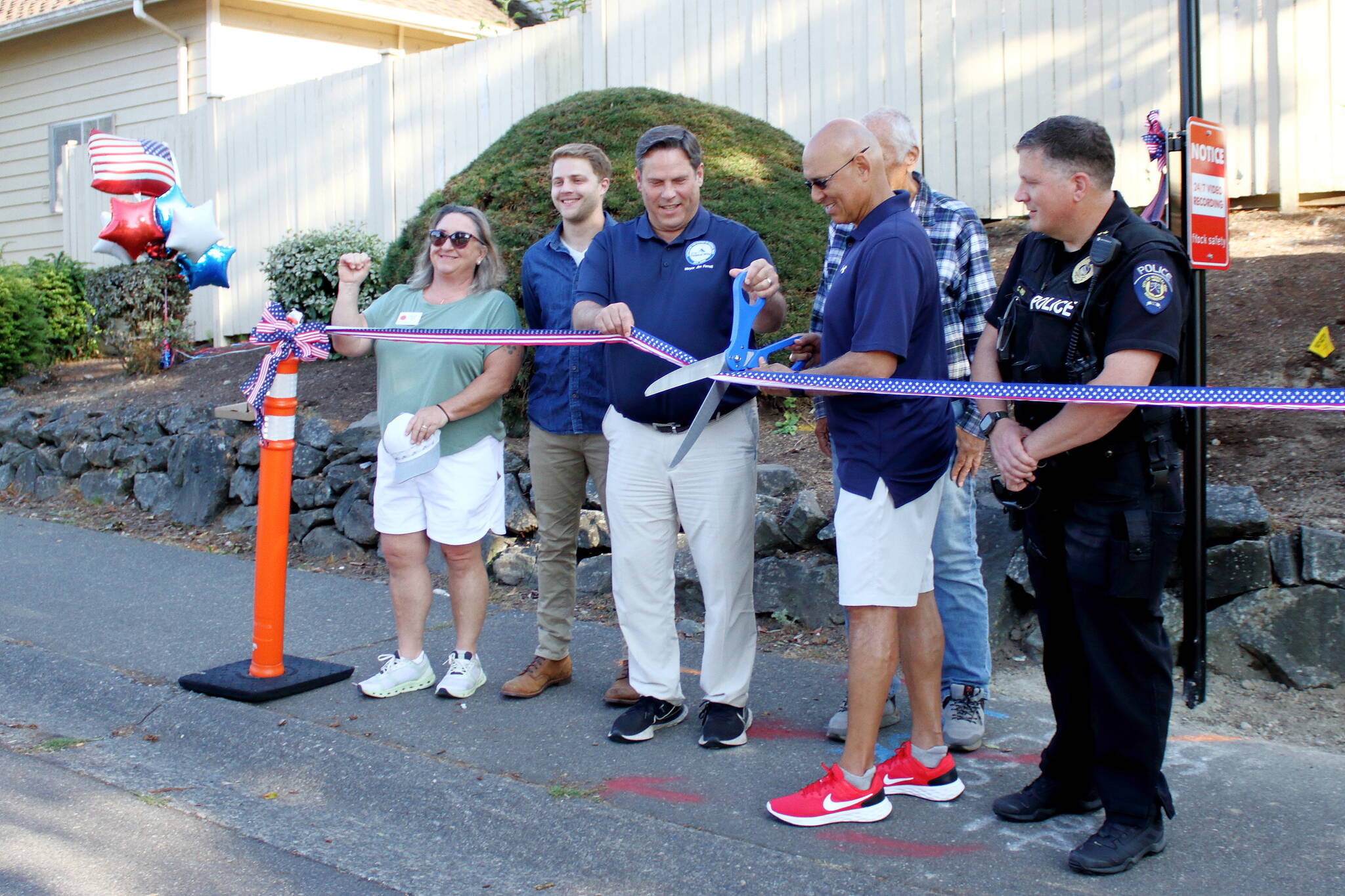 Local leaders cut the ribbon Aug. 6 for a new license plate scanning camera that is intended to increase public safety in the Westridge neighborhood in Federal Way. Photo by Keelin Everly-Lang / the Mirror