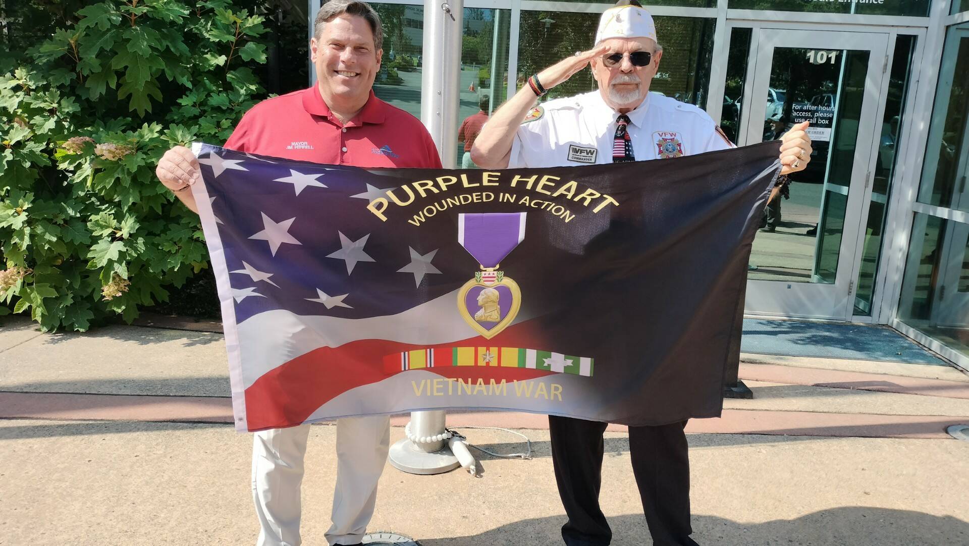 Federal Way Mayor Jim Ferrell and Roger Flygare with the Purple Heart flag before it was raised. Photo courtesy of Bill Vadino