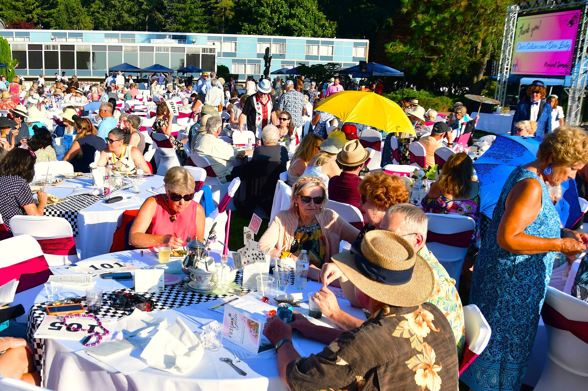 The lawn was packed with guests at FUSION’s Annual Gala - this year with an Alice in Wonderland theme and a new jumbotron screen to share their story throughout the night. Photo by Bruce Honda.