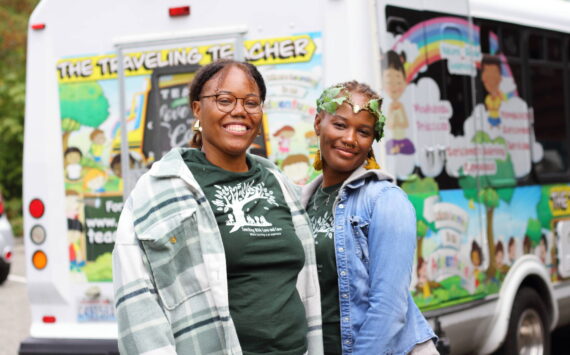 Asiyah Davis and Catrice Dennis in front of their mobile classroom: a bus painted with colorful and positive illustrations. Photos by Keelin Everly-Lang / the Mirror