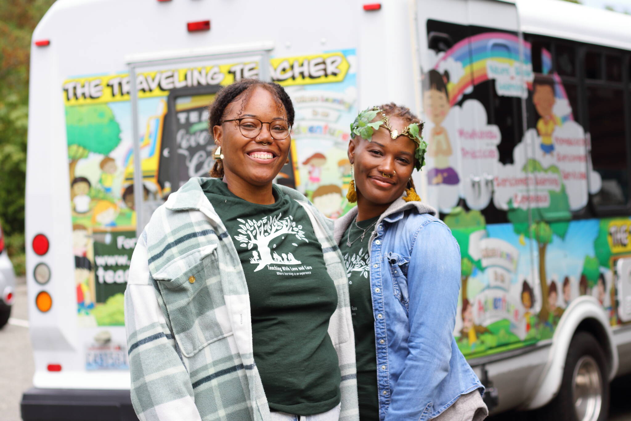 Asiyah Davis and Catrice Dennis in front of their mobile classroom: a bus painted with colorful and positive illustrations. Photos by Keelin Everly-Lang / the Mirror