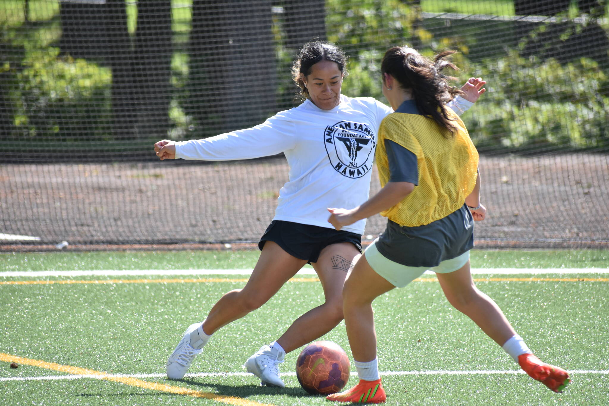 Decatur softball shortstop Kahea Sharpe (white) is giving soccer a go this year. Ben Ray / The Mirror