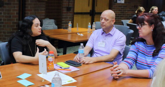 Katya Wojcik, cofounder and executive director of Project Be Free, and Landon Meyer of the Kent Police Department, connect with other leaders at the South King County City Leaders Breakfast on Sept. 10. Photo by Keelin Everly-Lang / the Mirror