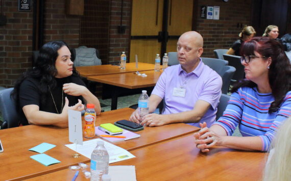 Katya Wojcik, cofounder and executive director of Project Be Free, and Landon Meyer of the Kent Police Department, connect with other leaders at the South King County City Leaders Breakfast on Sept. 10. Photo by Keelin Everly-Lang / the Mirror