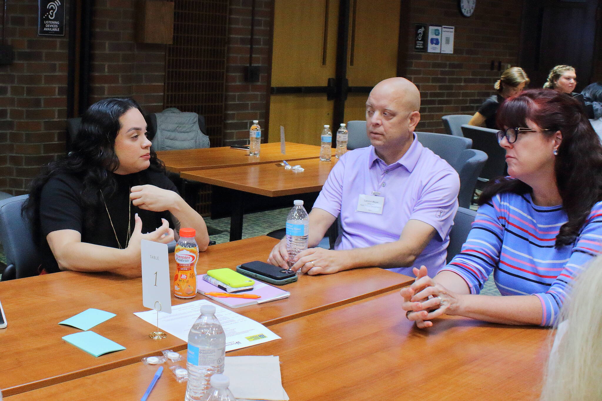 Katya Wojcik, cofounder and executive director of Project Be Free, and Landon Meyer of the Kent Police Department, connect with other leaders at the South King County City Leaders Breakfast on Sept. 10. Photo by Keelin Everly-Lang / the Mirror