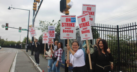 Workers stand outside of the Renton Boeing plant on the first day of the strike. Photo by Bailey Jo Josie/Sound Publishing.