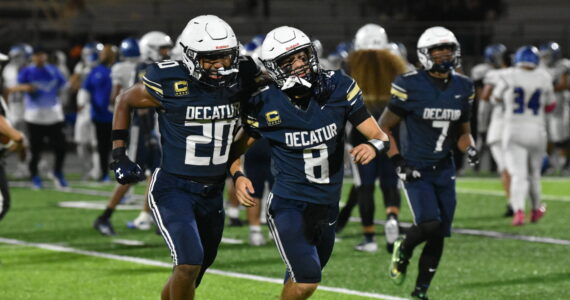 Maddox Heyliger (20) and Spencer Holloway (8) celebrate by running over to fans together after defeating Federal Way. Ben Ray / The Mirror