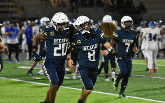 Maddox Heyliger (20) and Spencer Holloway (8) celebrate by running over to fans together after defeating Federal Way. Ben Ray / The Mirror