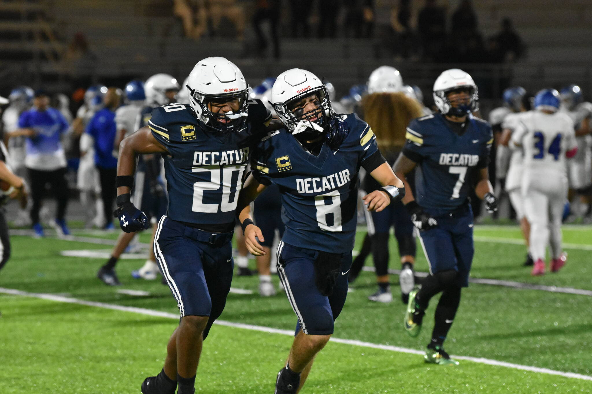 Maddox Heyliger (20) and Spencer Holloway (8) celebrate by running over to fans together after defeating Federal Way. Ben Ray / The Mirror