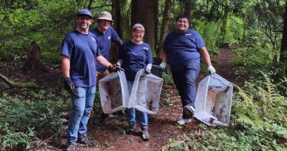 Volunteers work to clear out trash and debris from within the Hylebos wetlands. From left to right: Don Palumbo, Craig Patrick, Trace Palumbo and Juan Juarez. Photo provided by Stand Up Federal Way Community.