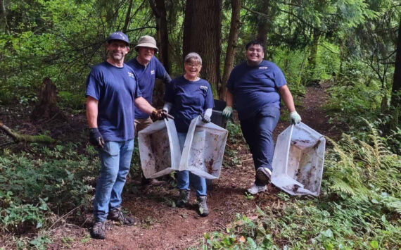 Volunteers work to clear out trash and debris from within the Hylebos wetlands. From left to right: Don Palumbo, Craig Patrick, Trace Palumbo and Juan Juarez. Photo provided by Stand Up Federal Way Community.