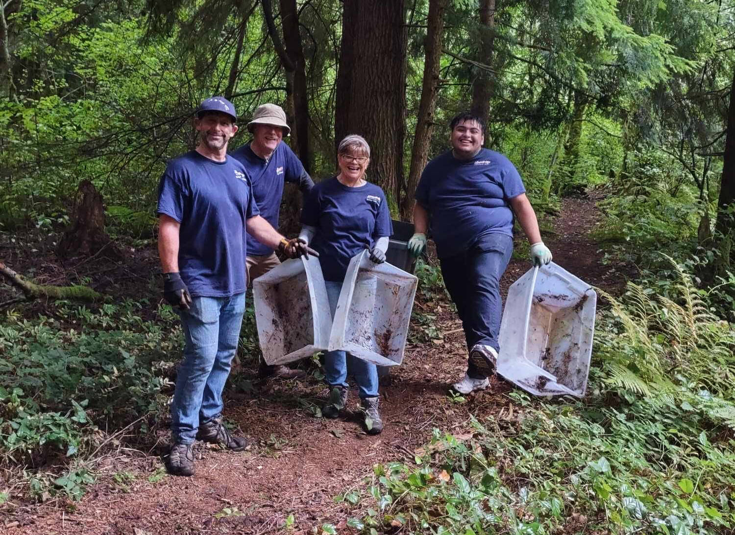 Volunteers work to clear out trash and debris from within the Hylebos wetlands. From left to right: Don Palumbo, Craig Patrick, Trace Palumbo and Juan Juarez. Photo provided by Stand Up Federal Way Community.