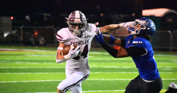 Enumclaw senior RB Louis Chevalier stiff arms an Eagle defender. Ben Ray / The Mirror